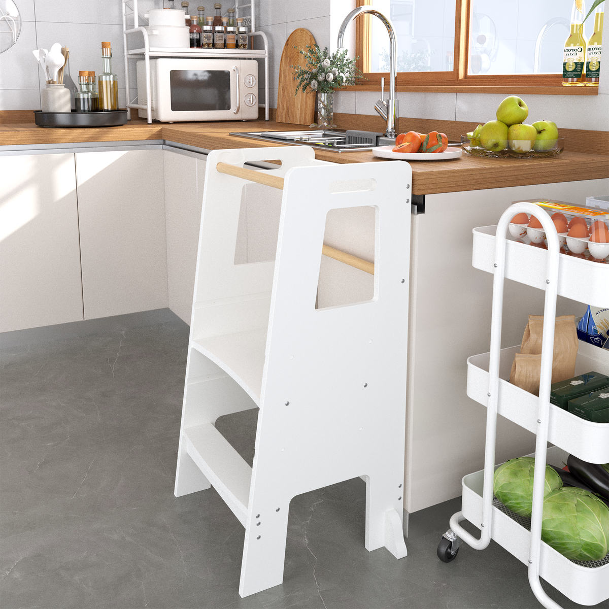 White toddler learning tower at a kitchen counter