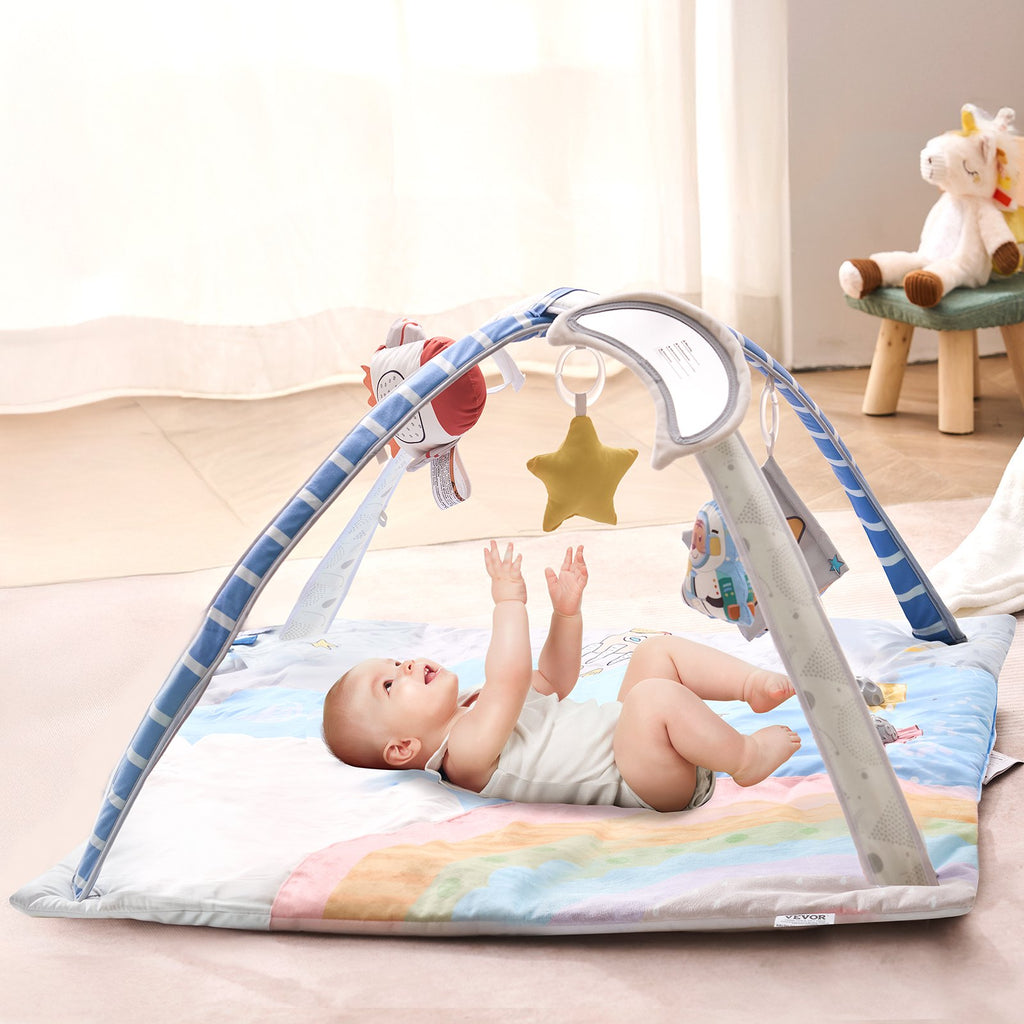 Baby lying under the Lovelyz tummy time play gym with hanging toys