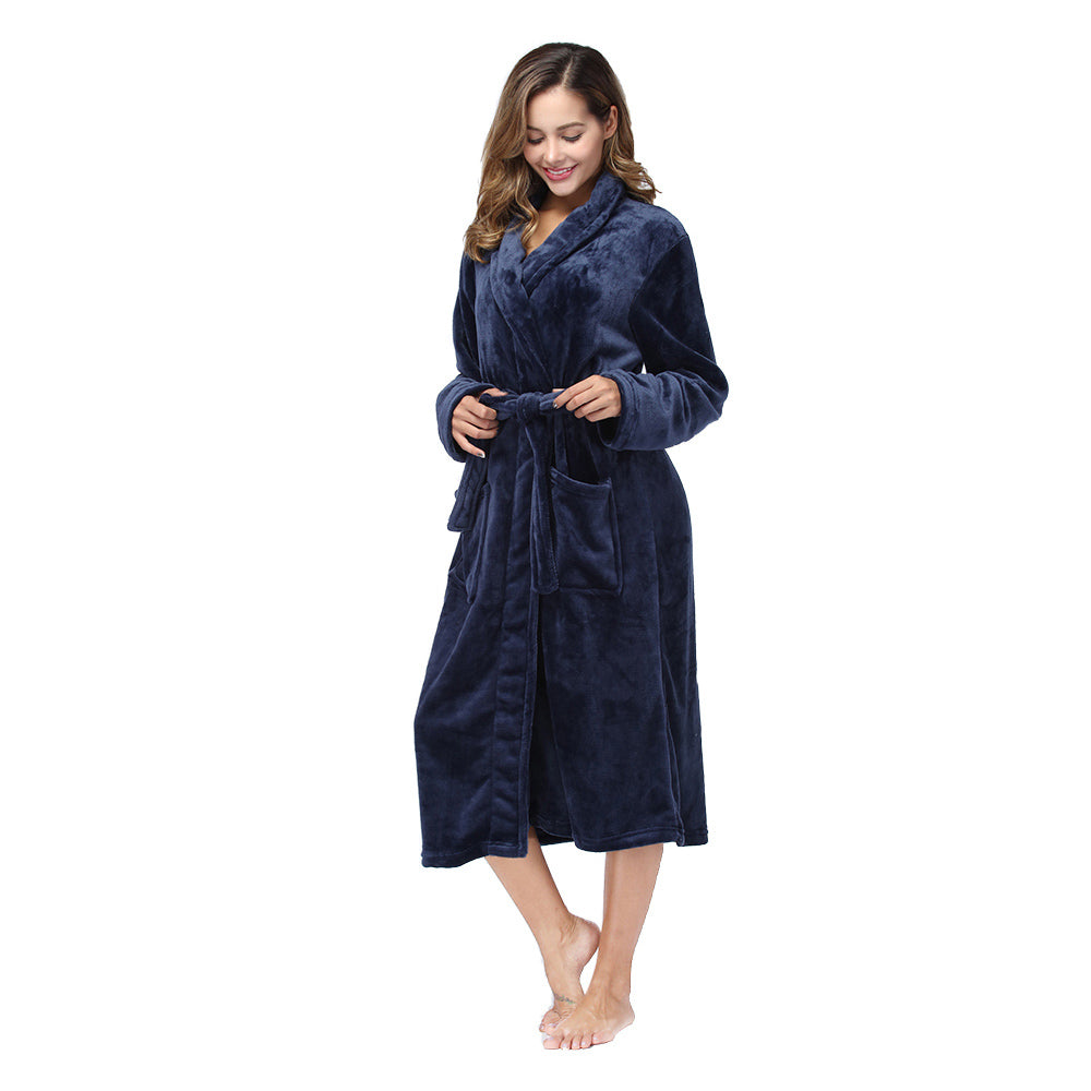 Woman tying the belt of the navy plush fleece robe